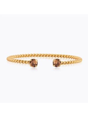 Caroline Svedbom Mini Twisted Armband – Guld / ReCreated Light Smoked Topaz 101348139701, handla denna klocka online eller i butik hos klockmaster