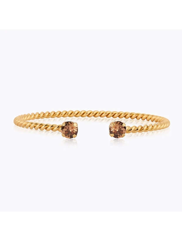 Caroline Svedbom Mini Twisted Armband – Guld / ReCreated Light Smoked Topaz 101348139701, handla denna klocka online eller i butik hos klockmaster
